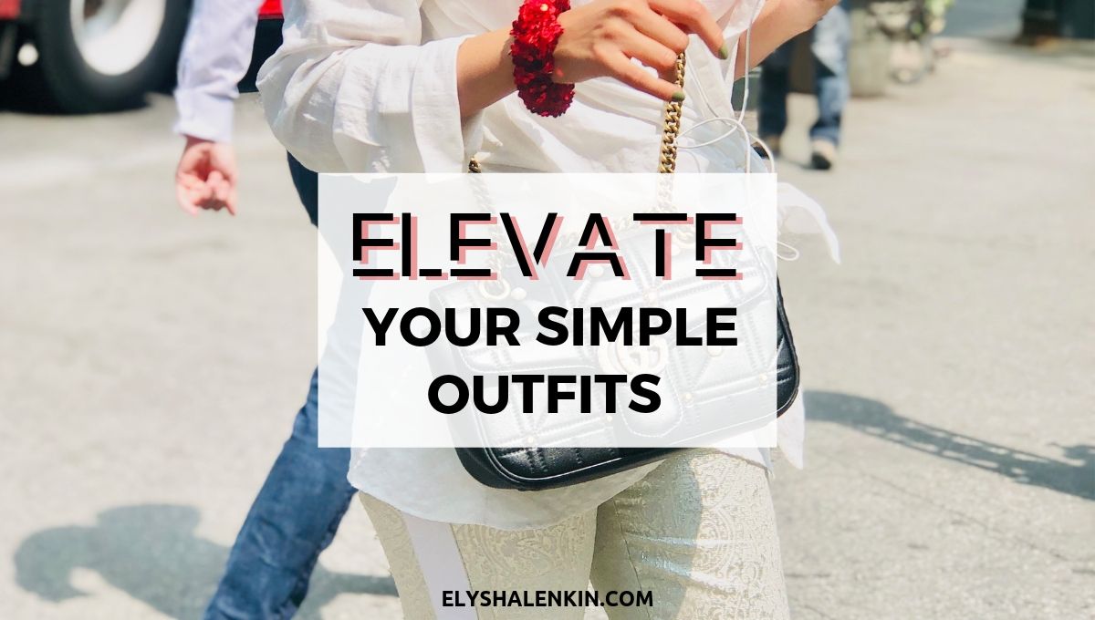 Elevate your simple outfits. Women walking across the street wearing a white outfit. She has a red scrunchy around her wrist and is holding a red phone.